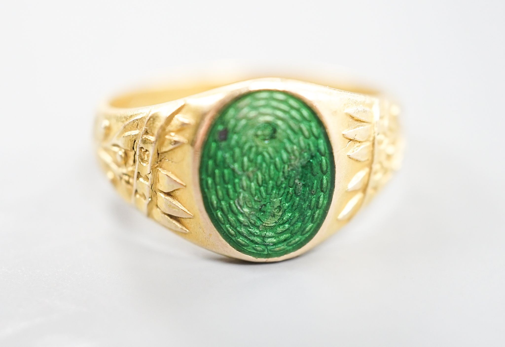 An early 20th century Austro-Hungarian (Vienna) 580/1000 yellow metal and green enamel signet ring, depicting the bust of a gentleman to sinister, size Q/R, gross 6.7 grams.